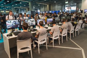 MILAN, ITALY - OCTOBER 24: People play at Games Week 2014, event dedicated to video games and electronic entertainment on OCTOBER 24, 2014 in Milan.