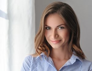 portrait of a beautiful young woman with perfect skin and beautiful hair closeup. Studio shot.